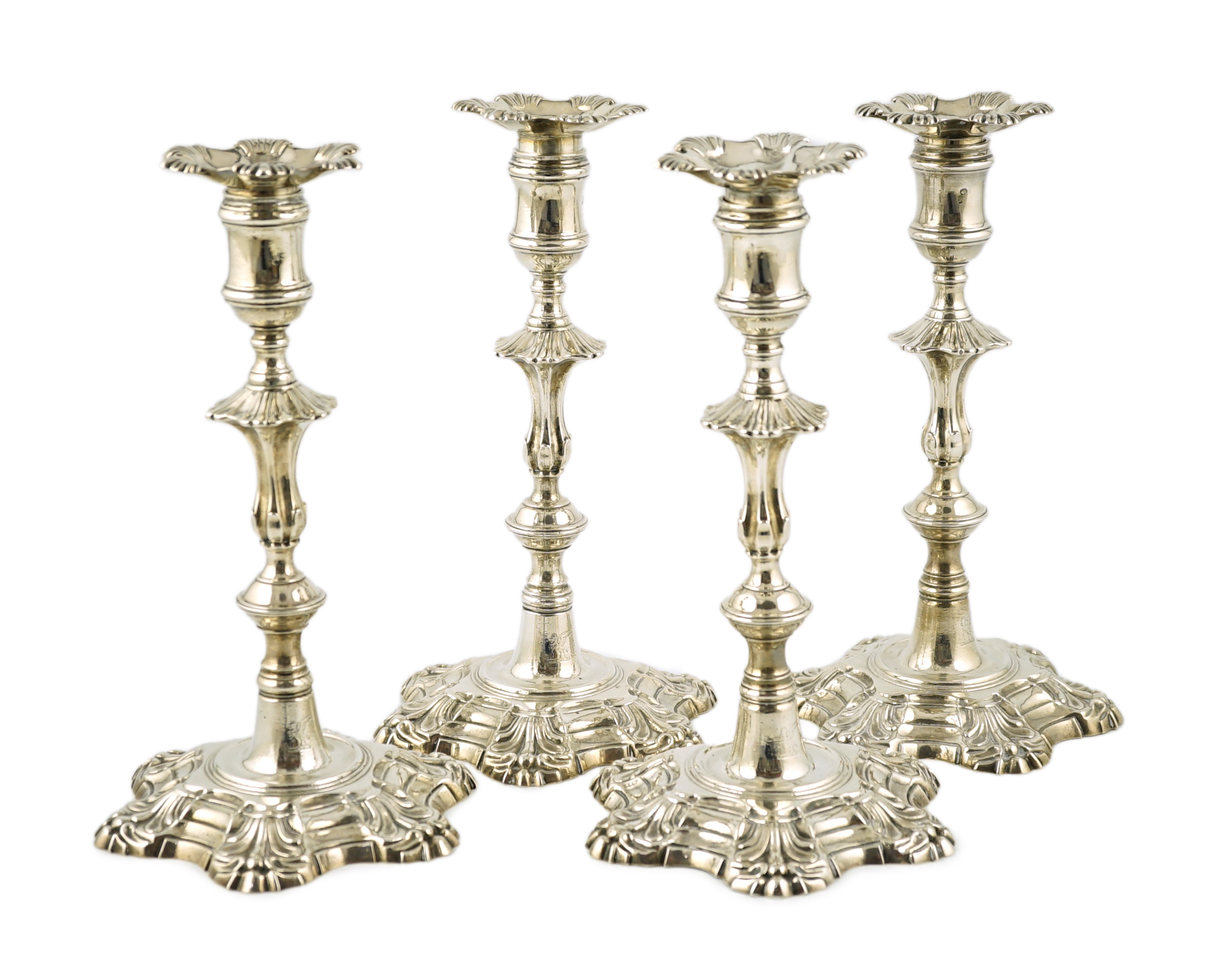 A set of four George II cast silver table candlesticks, by John Cafe